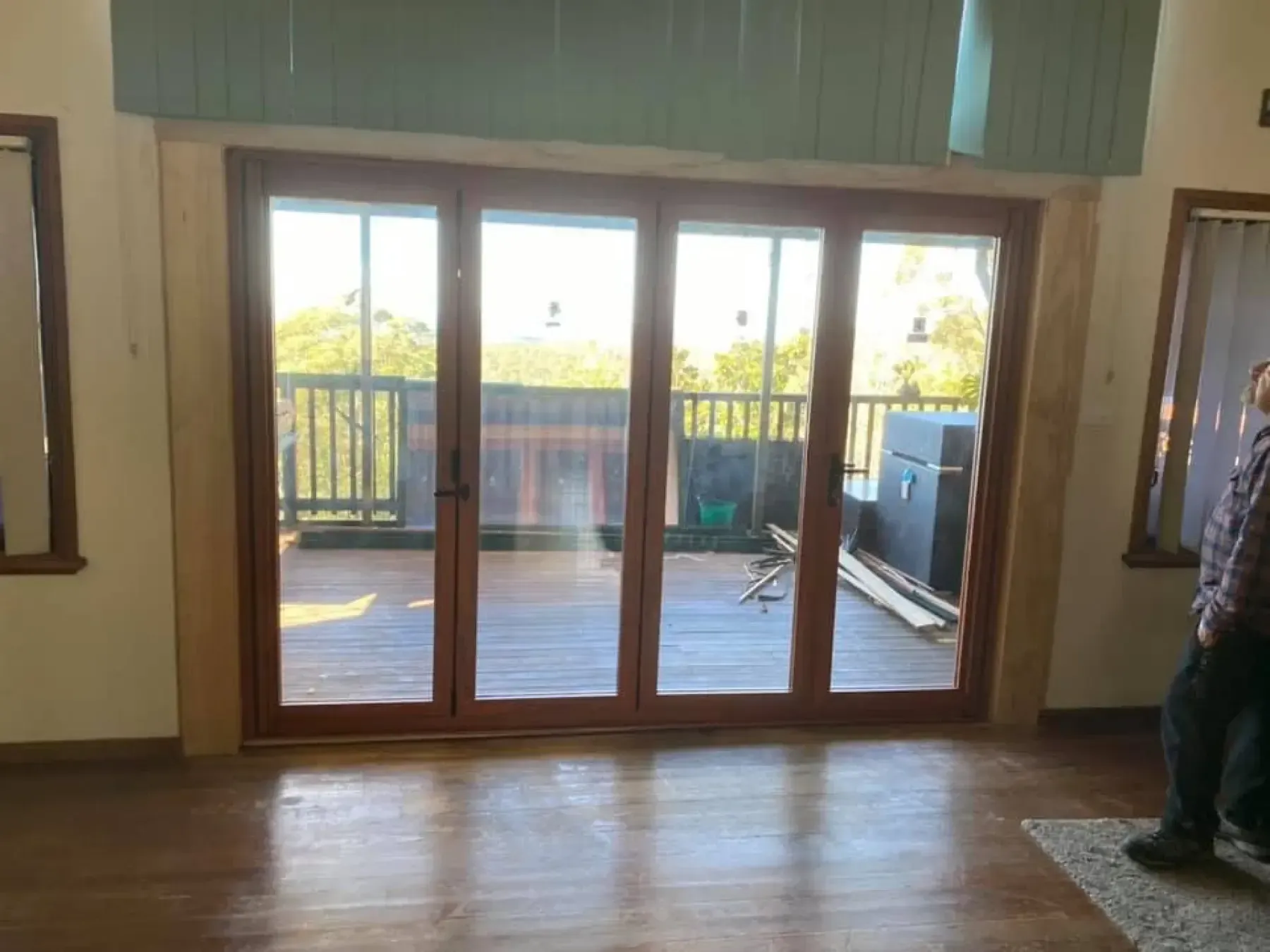 Timber French doors opening from a living room onto a covered deck