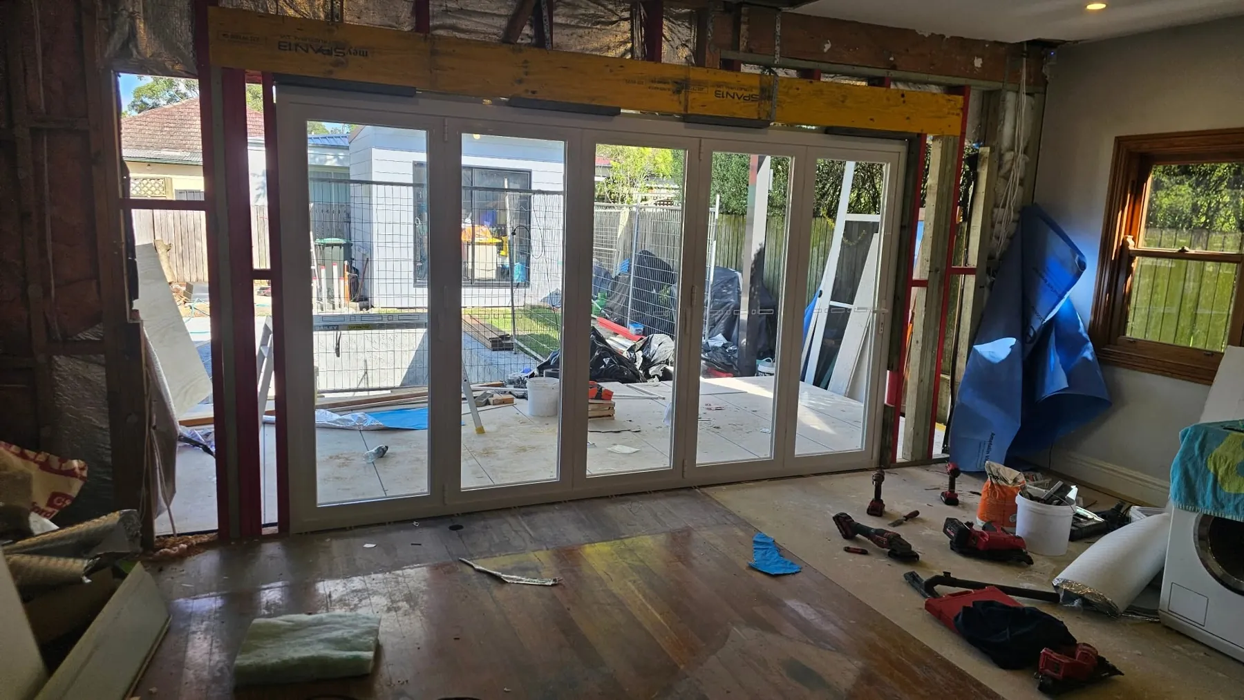 New white bifold doors installed in an opening during a room conversion