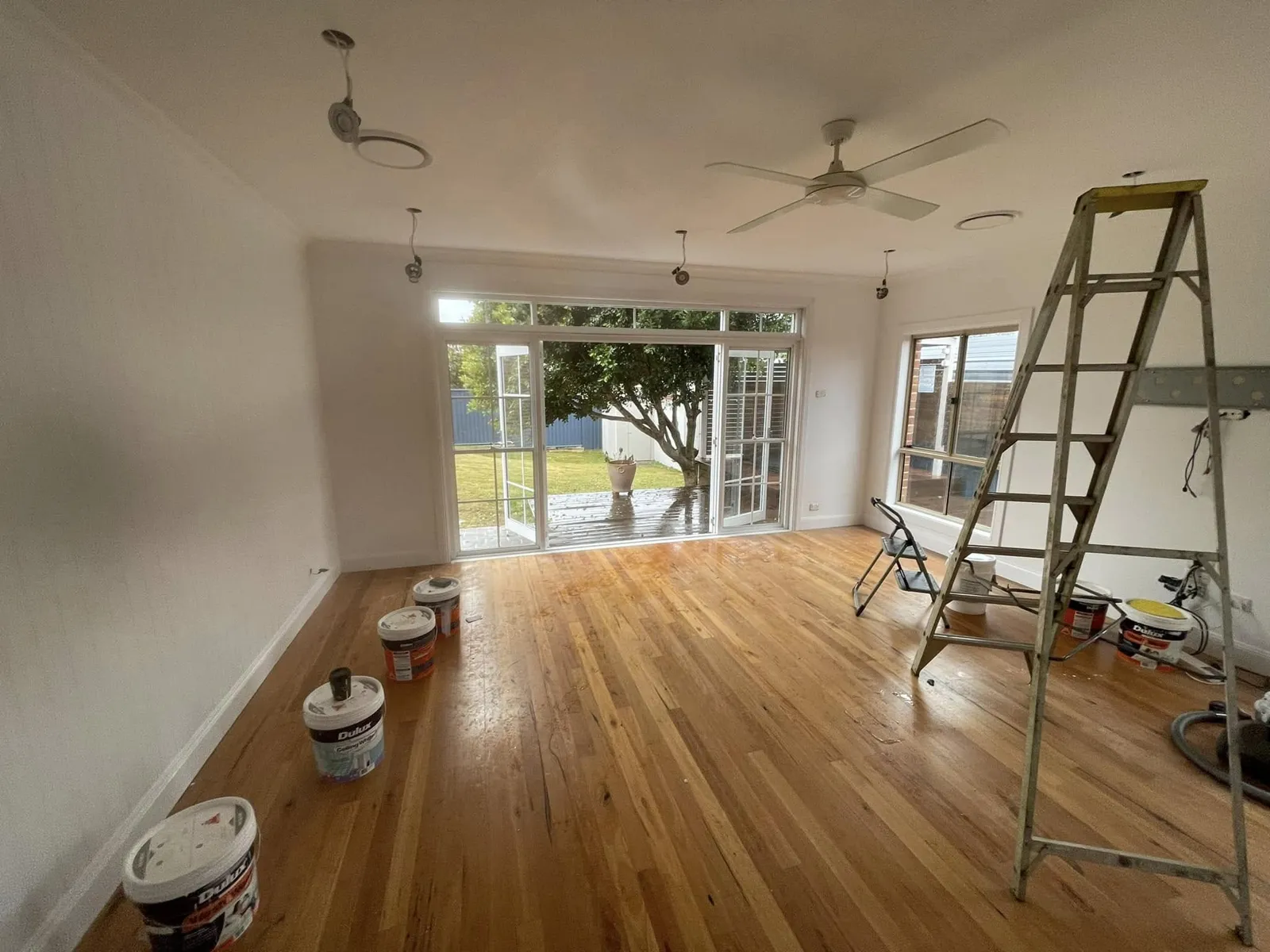 Room renovation in progress with timber floors and new French doors to the garden
