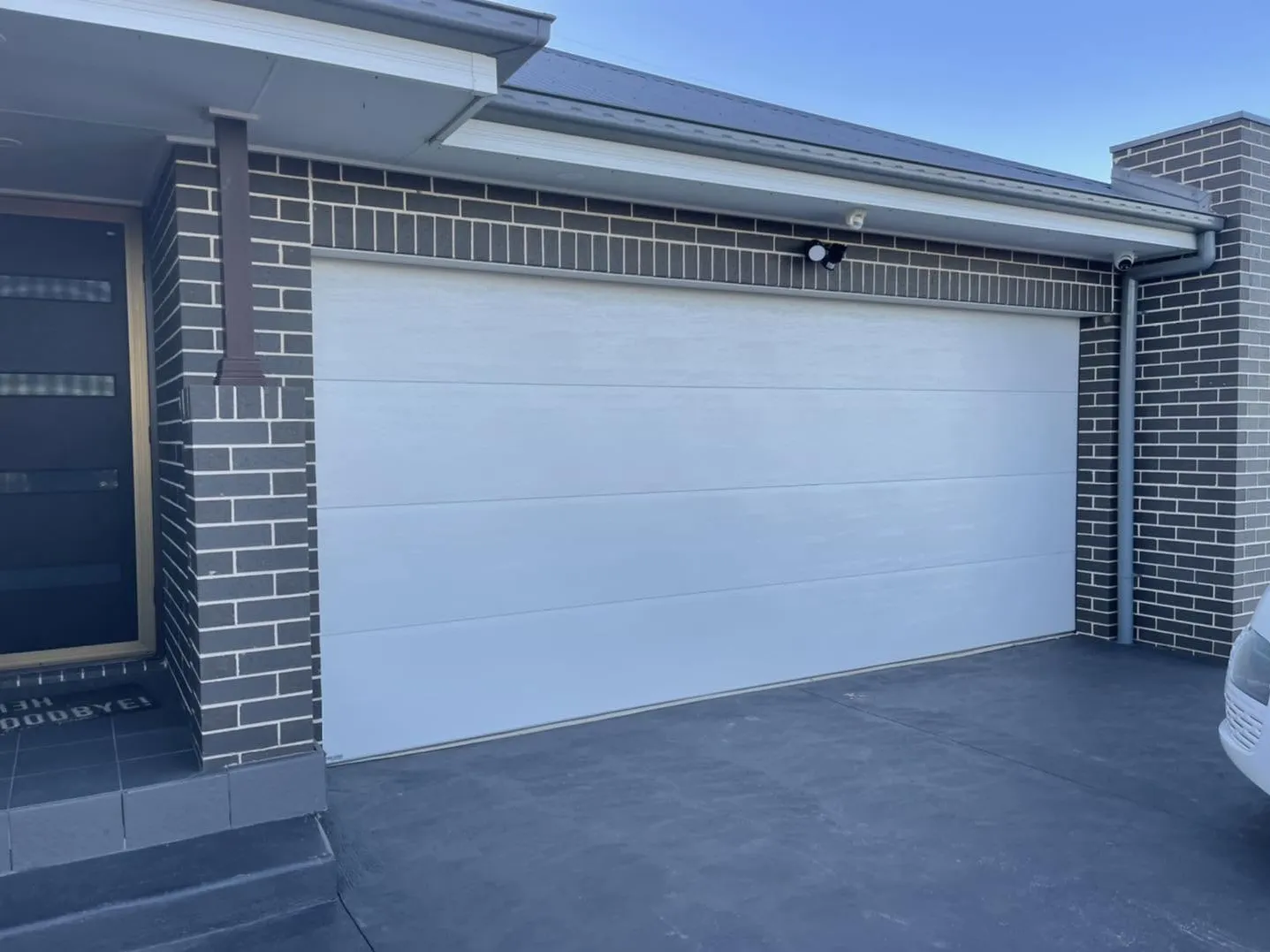 Garage with a white roller door before conversion