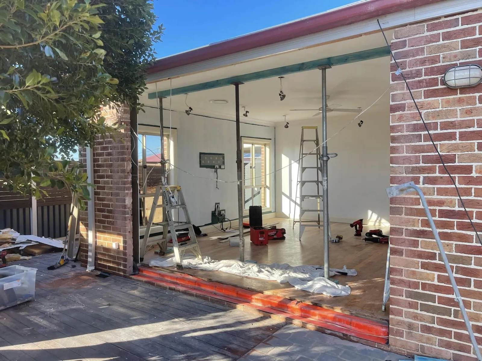 Open brick patio under construction before enclosure