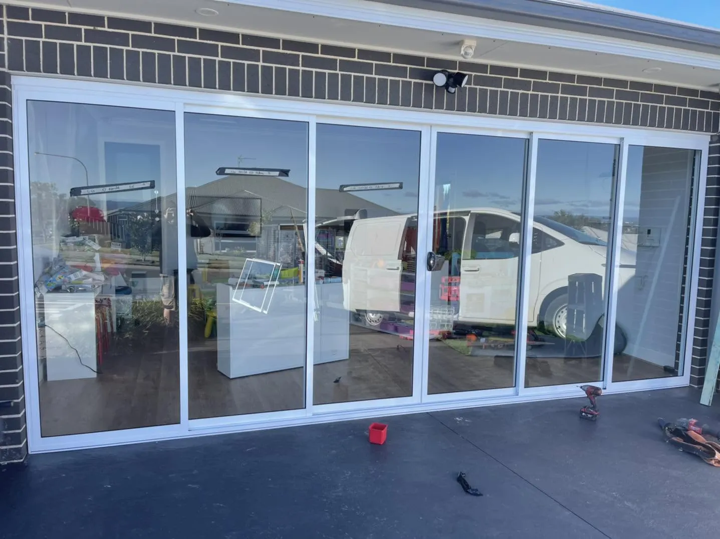The garage converted with a wall of glass sliding doors