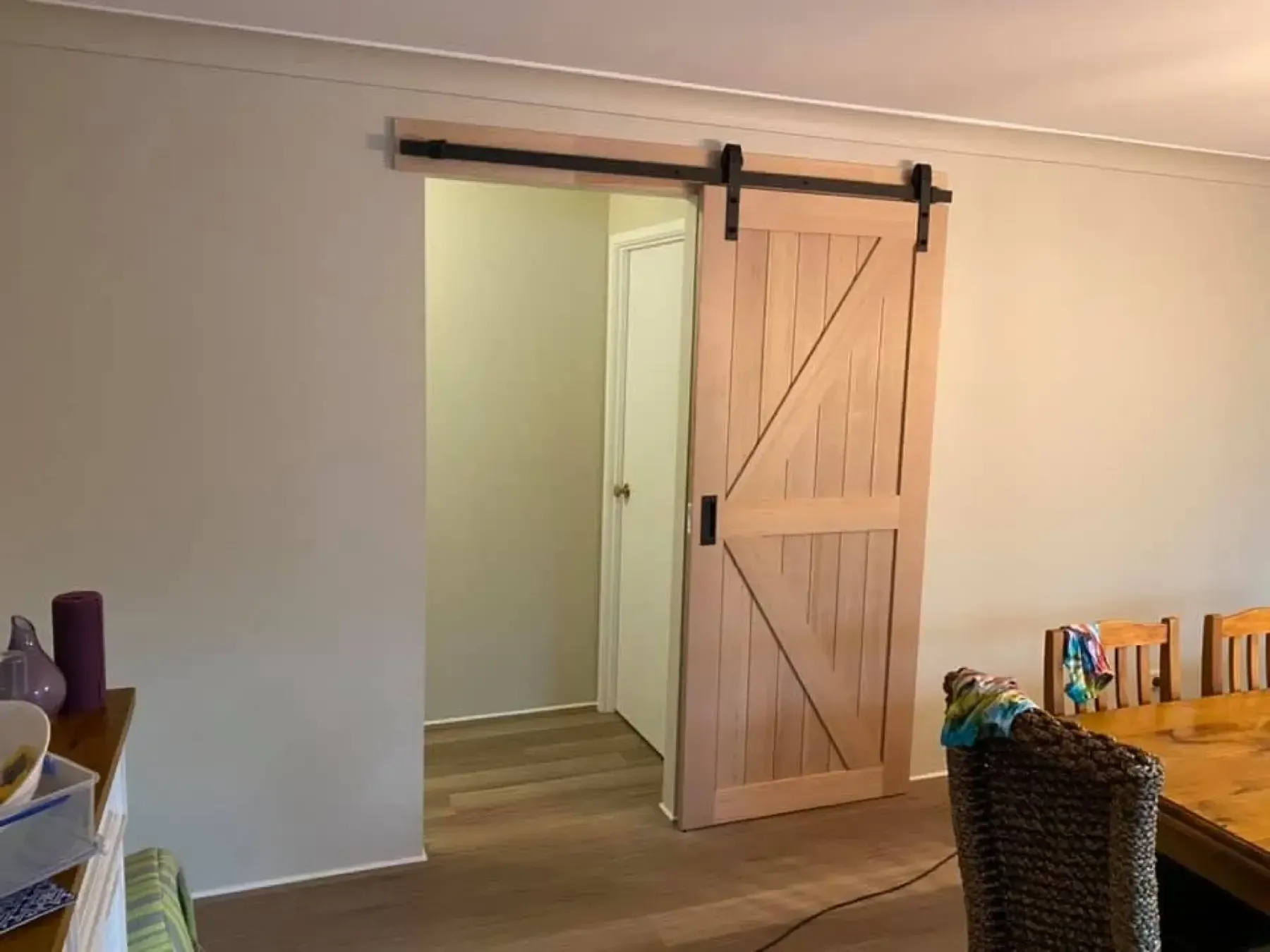 Timber barn-style sliding door installed inside a home
