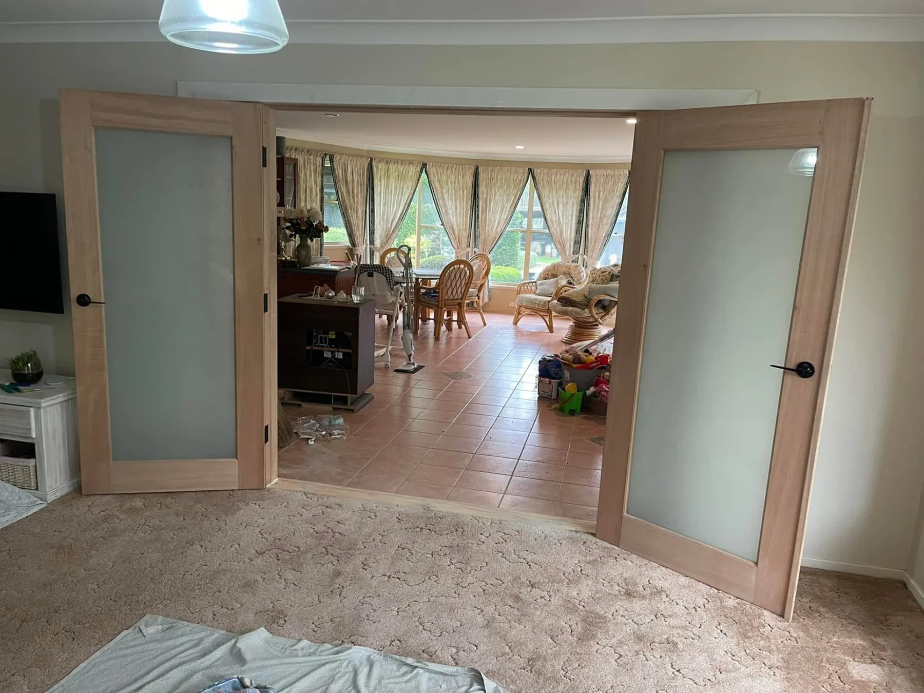 Timber French doors with frosted glass fitted in an internal opening
